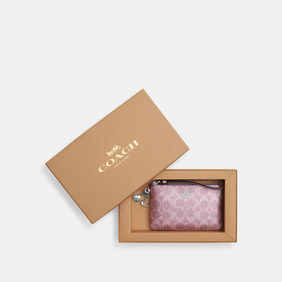 Coach Handbags - COACH Wristlet In Signature Pink Canvas w/Charms. Gift boxed NWT